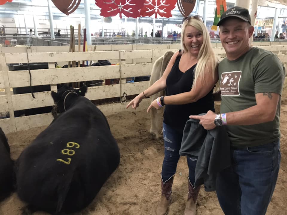 Anne and Danny with their steer at livestock auction.
